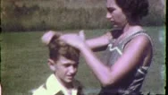 Woman Mom Combs Boys Hair Unhappy Son Kid Child 1950S Vintage Film Home Movie Stock Footage