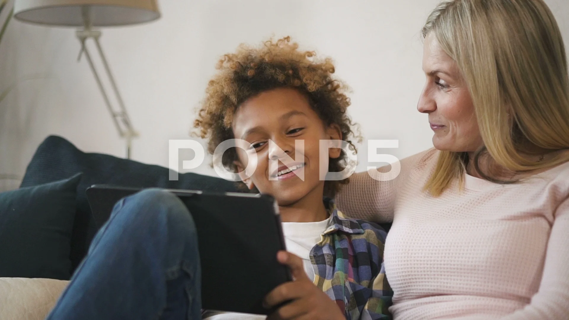 woman Mom with her son sitting on sofa a... | Stock Video | Pond5