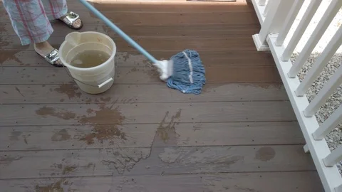 A woman mopping a deck Stock-Footage 108702978