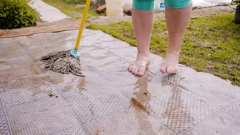 Woman mopping linoleum on the plot after the rain. Linoleum very wet. Close up Vídeos de archivo 108948292