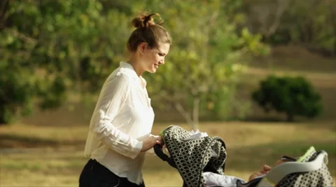 Woman Mother Mom With Little Baby in Stroller Sneezing For Allergy In Park Stock Footage 48217202