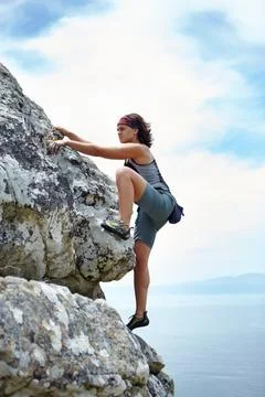 Woman, mountains and rock climbing on blue sky for sports, outdoor adventure and Stock Photos