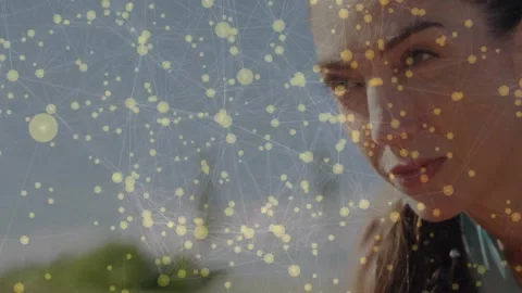 Woman moving closer while camera pushing in, yellow nodes drifting to reveal Video stock 331026206