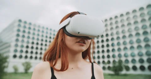 A woman moving her head while using augmented reality goggles Stock Footage 201119278