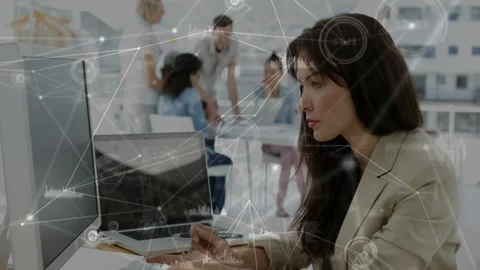 Woman moving mouse, activating tech graphs overlaying monitor, reviewing data Stock Footage 332505272