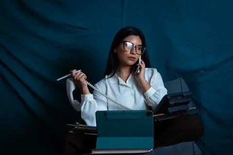 Woman multitasking, managing multiple calls and devices Stock Photos