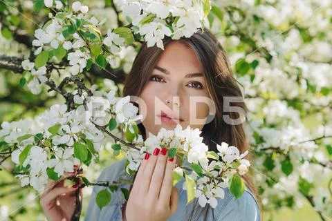 Woman near blooming apple tree Stock Photos