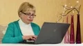 Woman with notebook. Senior woman types text uses laptop HD Footage