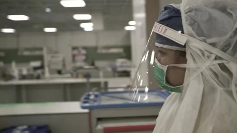 Woman nurse with protective clothing and hijab walking in the hospital Stock Footage