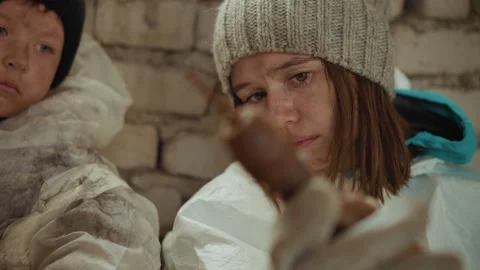 Woman Observes Rusted Object in Cold Brick Shelter Beside Child Video stock 329464917