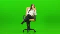 The woman on the office chair talking on the green background 4k or 4k+ Resolution