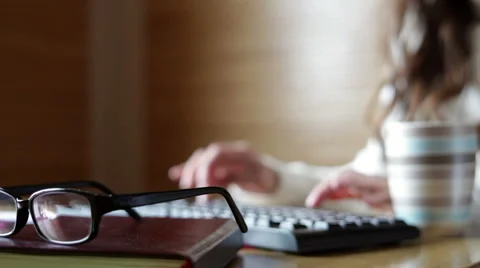 Woman in the office at the computer typing 스톡 동영상 50172914