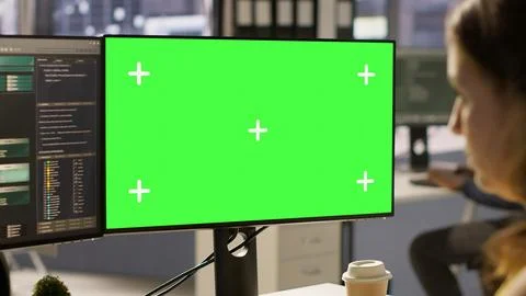 Woman in office fixing coding issues using green screen computer Stock Photos