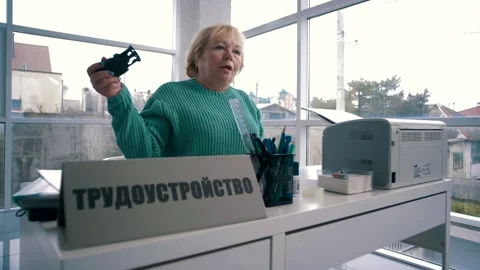 Woman in the office screams while sitting at the table with a seal Stock Footage 151646853