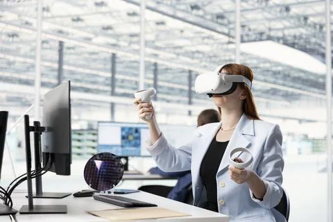 Woman in office testing microchip electronics prototypes using VR technology Stock Photos