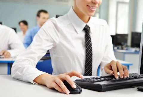 Woman office worker using computer on her workplace Stock Photos