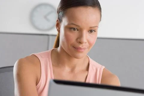 Woman in office working on computer Stock Photos