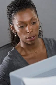 Woman in office working on computer Stock Photos