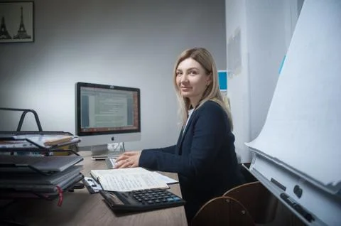 Woman at office working on computer Stock Photos