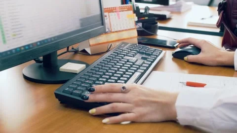 Woman in the office working with spreadsheets at the computer Stock Footage 197028883