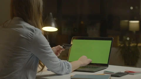 Woman online pay card back view in evening. Woman using credit card for internet Video stock 150494053