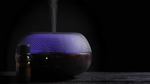 Woman open Diffuser for essential oil on black wooden table Stock Footage 150910410