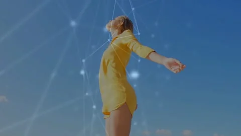 Woman opening arms as camera dropping, glowing network nodes expanding over her Stock Footage 334013654