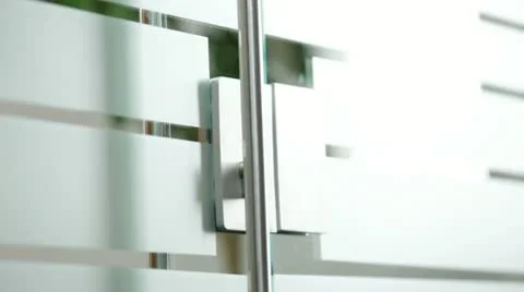 Woman opening glass door to office Stock Footage