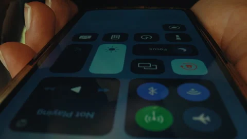 Woman opens control center on iphone use features Stock Footage 255132680