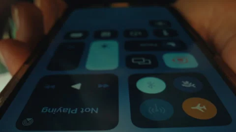 Woman opens control center on iphone use features Stock Footage 276186180