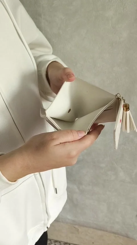 A woman opens an empty wallet close-up. The concept of unemployment, crisis Video stock 325290036