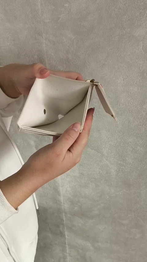 A woman opens an empty wallet close-up. The concept of unemployment, crisis Stock Footage 325290286