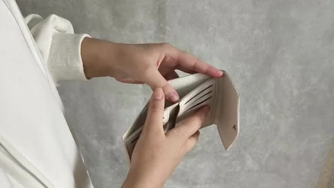 A woman opens an empty wallet close-up. The concept of unemployment, crisis Stock Footage 325290358