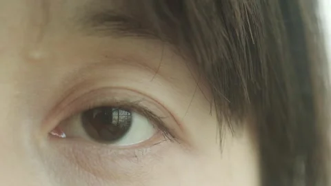 Woman Opens Eye in Soft Light Extreme Close-up Portrait Vídeos de archivo 334639146