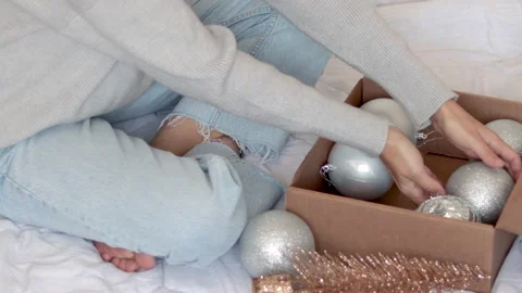 Woman opens gift box remove christmas silver glitter balls toys Stock Footage 220333431