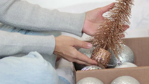 Woman opens gift box remove christmas silver glitter balls,decorative fir tree Stock Footage 220868697