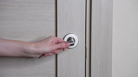 The woman opens the interior door. Interior. Door handle. Stock Footage 167366160