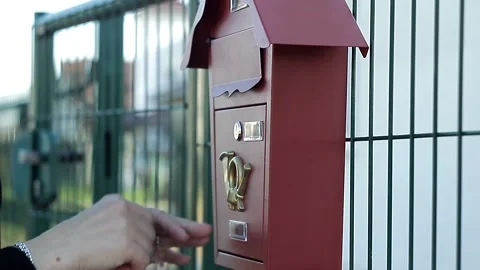 Woman opens with a key a beautiful empty mailbox outside the house Stock Footage 162272439
