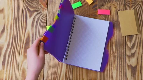 Woman opens notepad and draws smile. Stock Footage 77728254