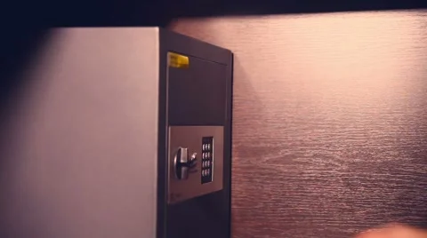 Woman opens a safe checks documents and closes the evening lamplight Stock Footage 56035225