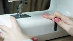 Woman sewing light fabric on a sewing machine close-up. Side view. Stock  Video Footage by ©familylifestyle #185667492