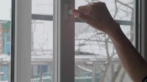 A woman opens a window Stock Footage 232604138