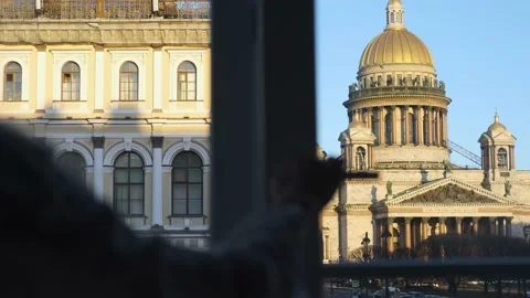 Woman opens a window with a view of St. Isaac's Cathedral Stock Footage 145646567