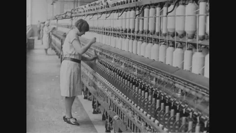 Woman operate machinery in the cotton factory - 1930 Stock Footage