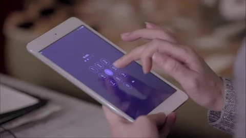 The woman is operating and using a tablet Stock Footage 265537709