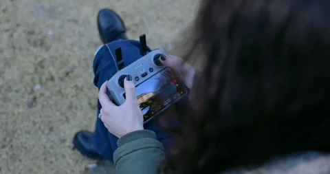 Woman Operating Drone Remote Controller Sitting Outdoors Stock Footage 345021878