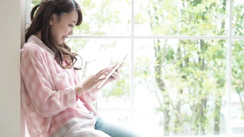 Woman Operating a Tablet PC Stock Footage 332773681