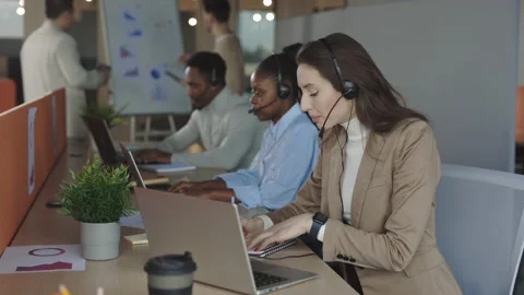 Woman operator in headset talking with client on laptop Stock Footage 196885951