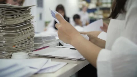 Woman organizing documents at a desk Stock Footage 301409510
