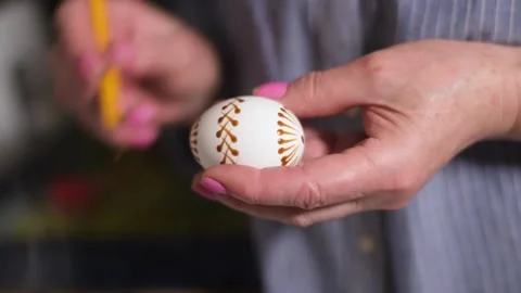 Woman paint Easter eggs in an authentic way with wax candles and paint. Home Stock Footage 131027944